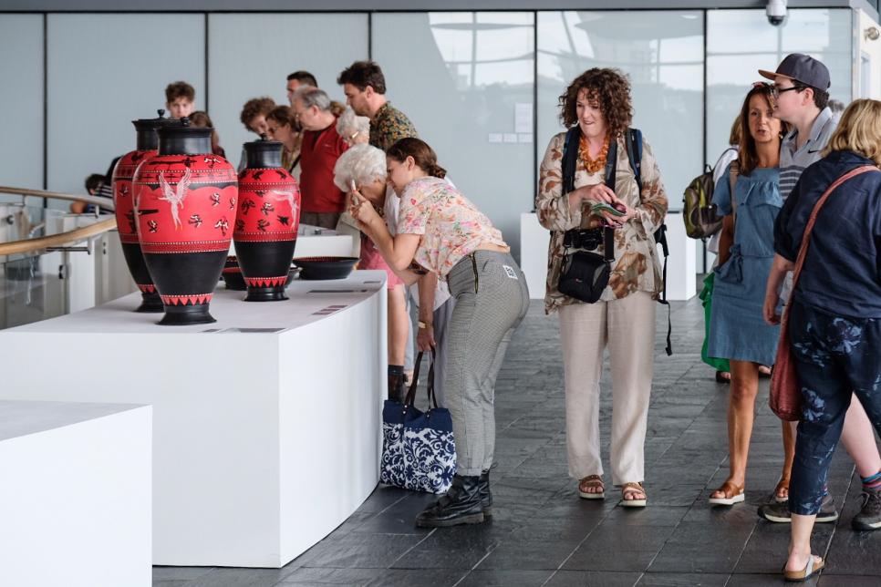 Visitors browsing the artwork on show at Y Lle Celf 2018 at the Senedd building in Cardiff.