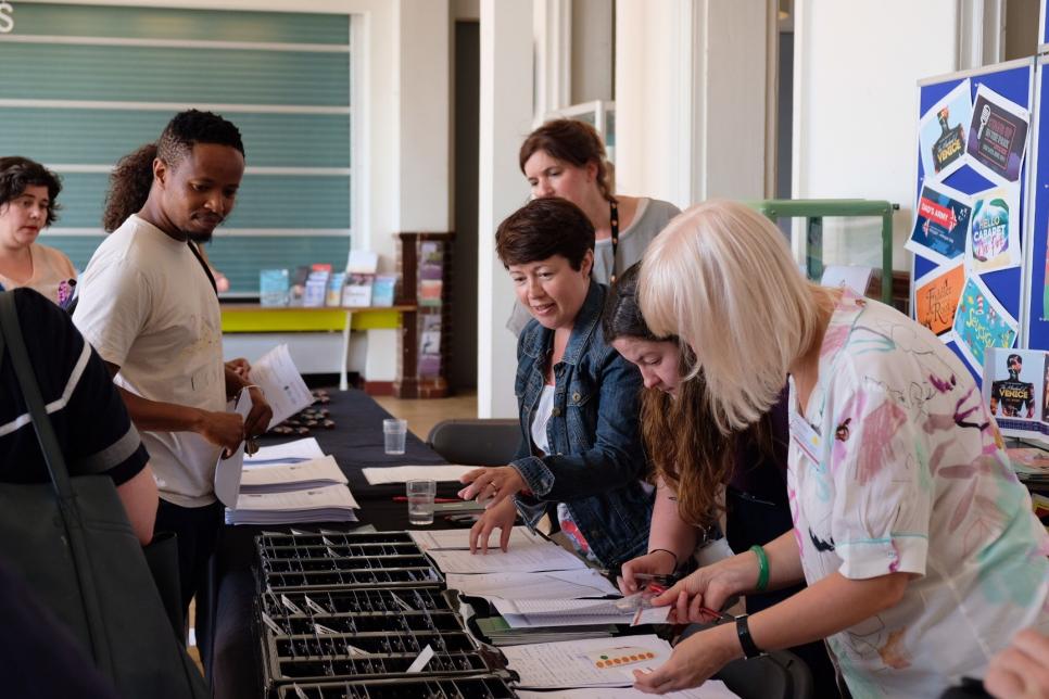 International Forum, Chapter Administrators giving out name badges at a makeshift welcome desk