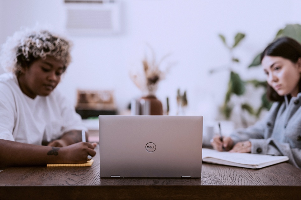 Two people looking at a laptop screen