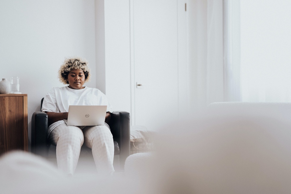 Person sitting down and typing on laptop