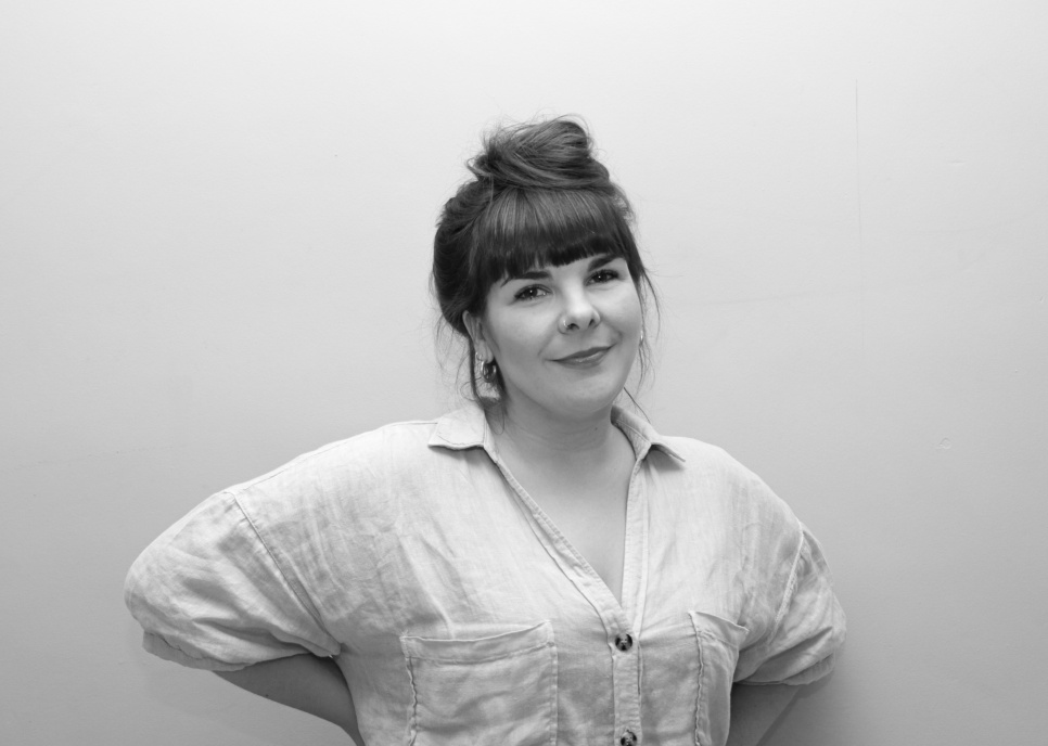 FREYA_DOOLEY - credit - Phoebe Davies A woman smiling with hands on hips, in black and white